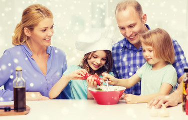 Obraz na płótnie Canvas happy family with two kids making salad at home