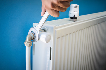 Man installing radiator valve close up