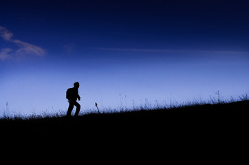 Climber silhouette on the grassland