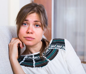 Portrait of miserable woman at home.