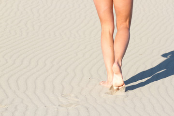 Women's legs from behind. Recreation. Blue sea