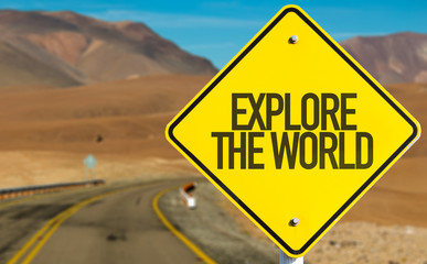 Naklejka premium Explore the World sign on desert road