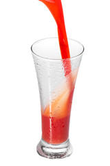 pouring tomato juice in a glass, isolated on white