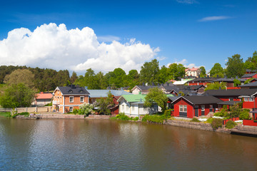 Fototapeta na wymiar Colorful wooden houses on river coast. Porvoo