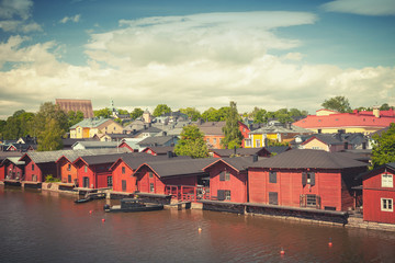 Fototapeta na wymiar Old red wooden houses on river coast in Porvoo