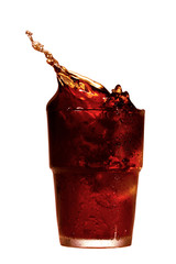 Splashing cola in glass. Isolated on white background
