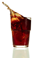 Splashing cola in glass. Isolated on white background
