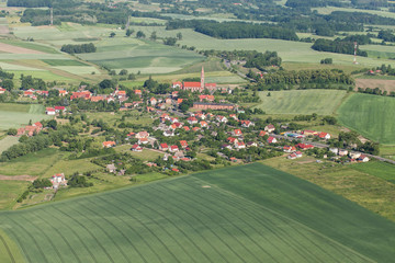aerial view of the  village and green harvest fields