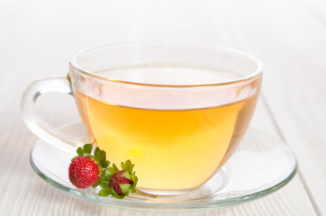 Cup of tea and strawbarries on the white wooden table
