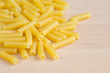 Macaroni pasta on a wooden board