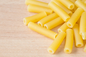 Macaroni pasta on a wooden board