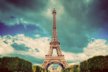 Fototapeta premium Eiffel Tower seen from Champ de Mars park in Paris, France. Vintage