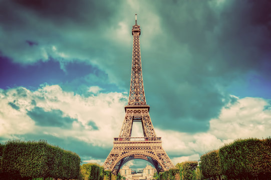 Eiffel Tower seen from Champ de Mars park in Paris, France. Vintage