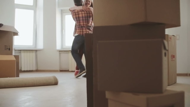 Young couple very happy and excited about moving into new apartment