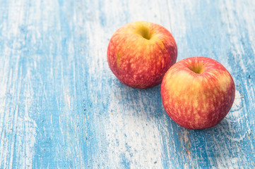 Red apple on the wooden floor.