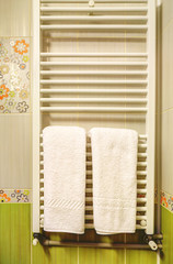 White towels on heater in a modern bathroom