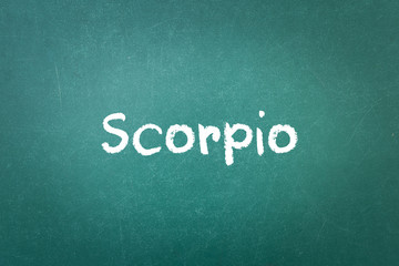 Green blackboard wall texture with a word Scorpio