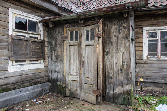 Abandoned wooden cottage door and windows.
