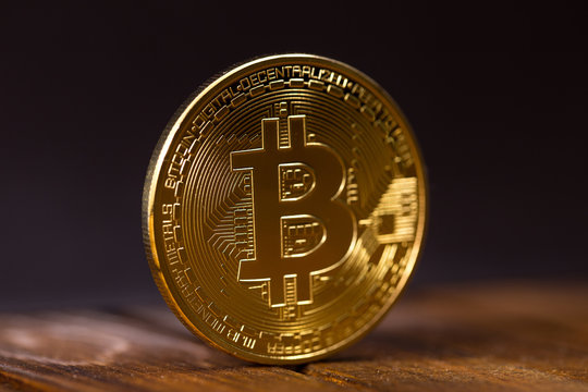 gold bitcoin on wooden table