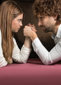 competition between man and woman on pink table
