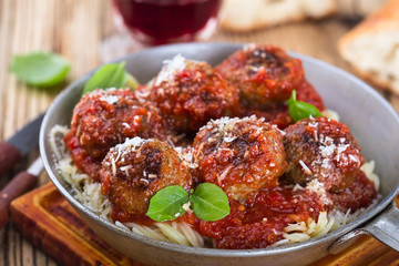 Homemade meatball with Italian pasta in frying pan 