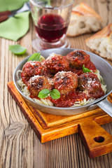 Homemade meatball with Italian pasta in frying pan 