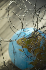 globe with barbed wire