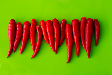 fresh red chili on green background.hot chili