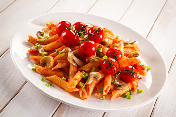 Penne with meat, tomato sauce and vegetables