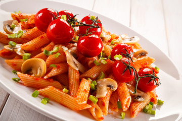 Penne with meat, tomato sauce and vegetables