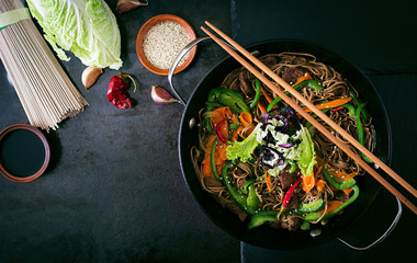 Soba noodles with beef, carrots, onions and sweet peppers - obrazy, fototapety, plakaty