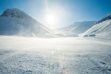 Beautiful white snowy landscape. Mountains and blue sky on the background. Sunny weather....