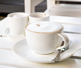 Coffee cup on white wooden table 