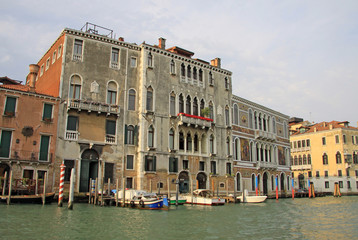 Fototapeta na wymiar VENICE, ITALY - SEPTEMBER 03, 2012: Old typical buildings on Grand Canal and parked gondolas, Venice, Italy