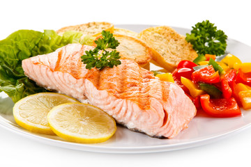 Grilled salmon and vegetables on white background 