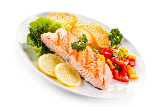 Grilled salmon and vegetables on white background 