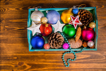 top view of vintage wooden box with Christmas decoration, tinsel