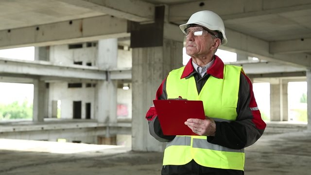 Inspector On Construction Site. Civil Engineer In White Hard Hat On Project Site. Engineering Supervision
