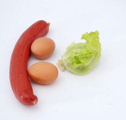 sausage eggs and lettuce  on white background