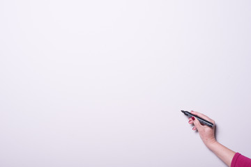 woman's hand with pen on whiteboard with copy space