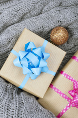 Christmas presents on a gray knitted background 