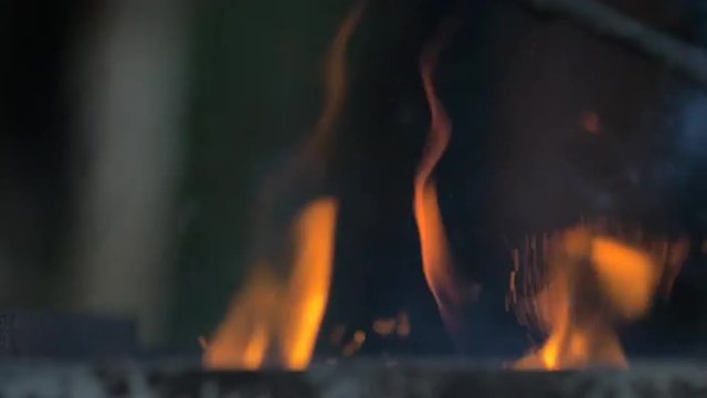 Slow motion of fire sparks in a grill 