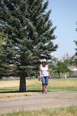 Mature female beauty walking in the park outdoors.