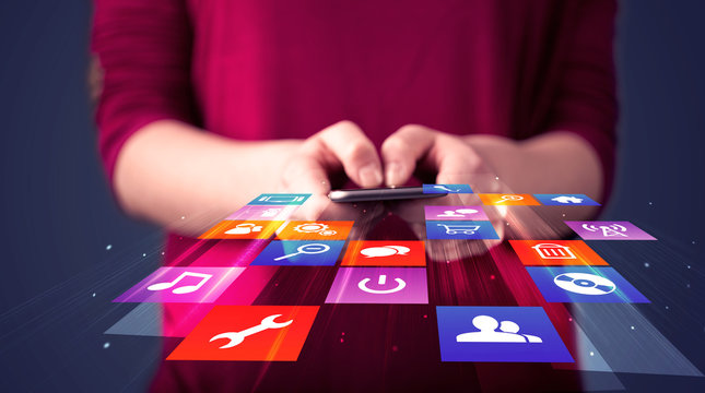 Woman holding smart phone with colorful application icons