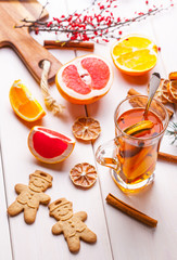 Winter hot drink with spices on wooden table.