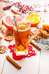 Winter hot drink with spices on wooden table.