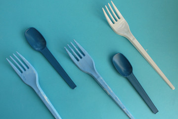 Blue and white fork and spoon on blue background - party time concept