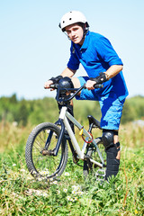 Fototapeta na wymiar cyclist with his bicycle bike on meadow