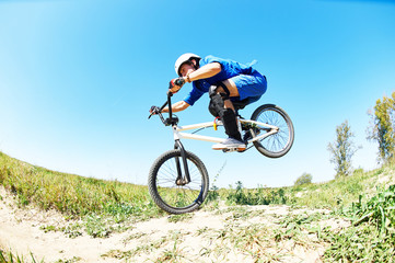 Fototapeta premium cyclist riding jumping with bicycle cross-country
