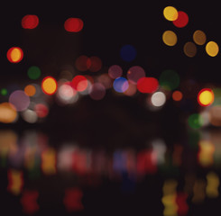 Blurred city lights with bokeh on water